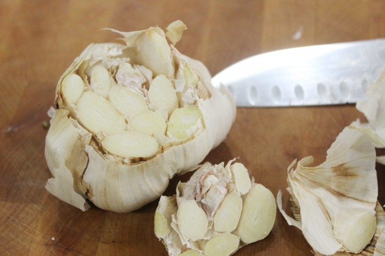 Cutting the top off of garlic head