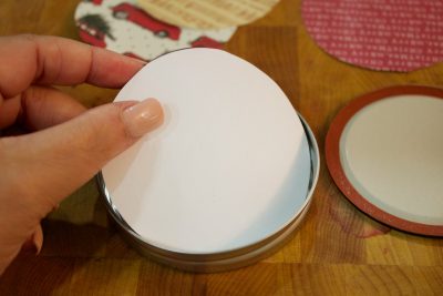 glueing-scarpbook-papers-in-lids-for-christmas-ornaments | The Everyday Home | www.everydayhomeblog.com