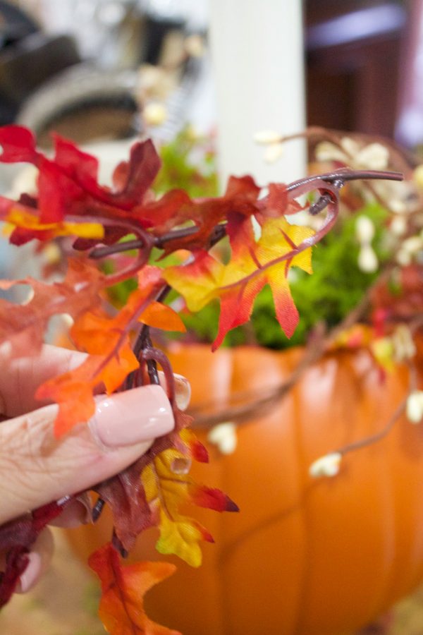 adding-sprigs-of-leaves-to-a-pmpkin-candleholder-planter | The Everyday Home | www.everydayhomeblog.com